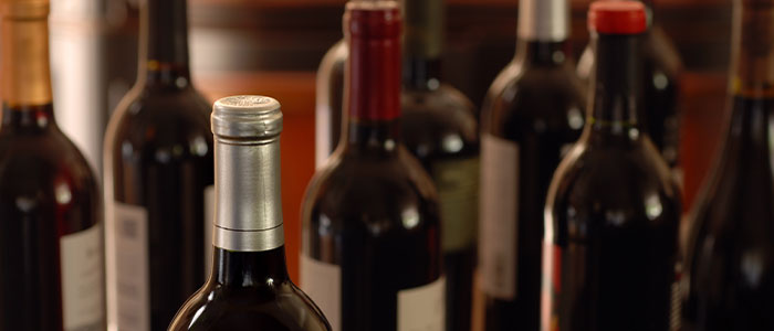 Several wine bottles with vibrant caps at Leku Ona Restaurant, Boise, Idaho—one in sharp focus.