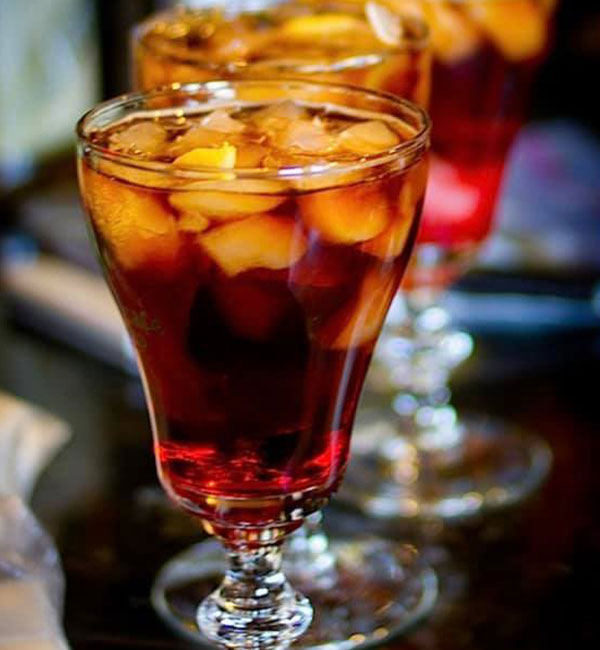 A glass of iced tea with lemon sits on a dark surface at Leku Ona Restaurant Boise Idaho.