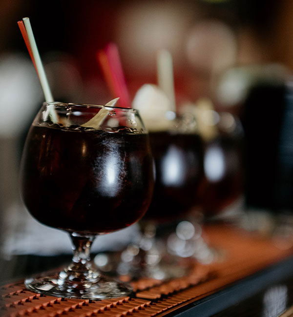 Three iced drinks with straws on the bar counter at Leku Ona Restaurant Boise Idaho.