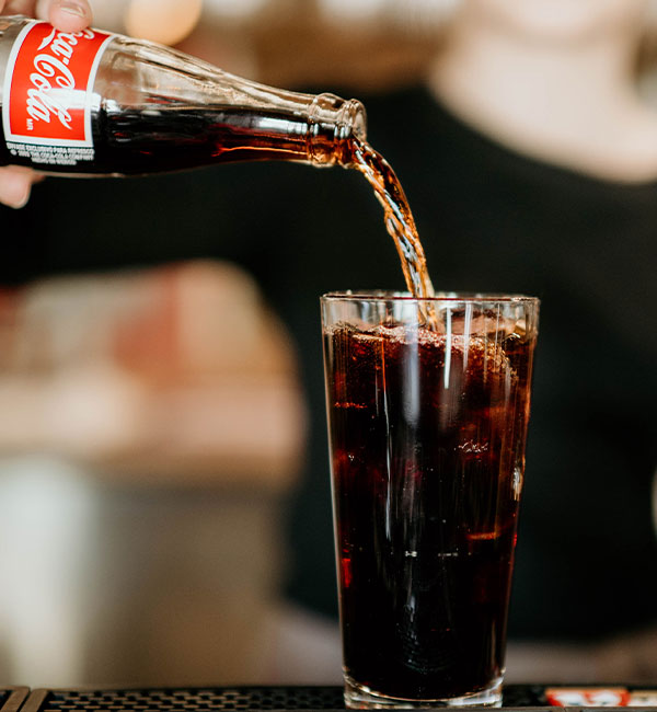 At Leku Ona Restaurant Boise Idaho, a glass bottle of Coca-Cola is poured over ice.