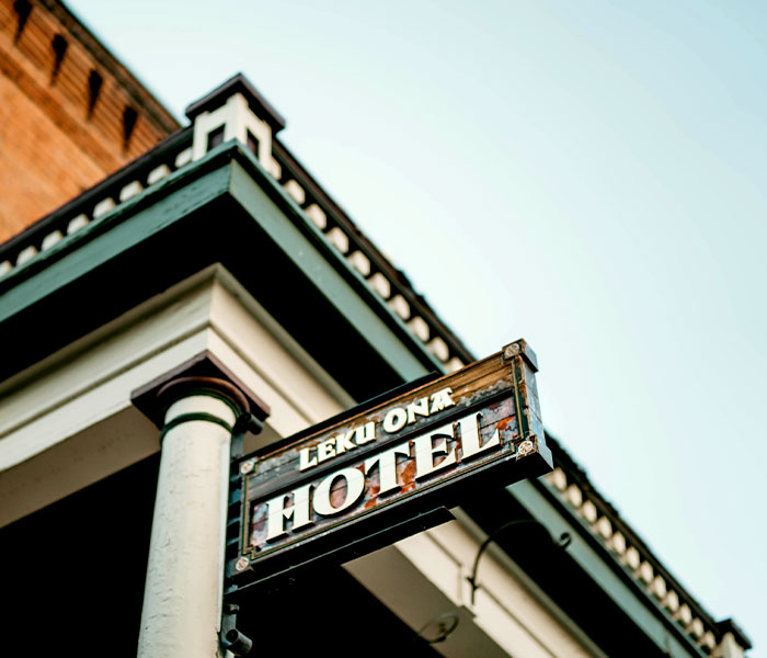 A vintage sign reading “Leku Ona Hotel” hangs near the Leku Ona Restaurant Boise Idaho.