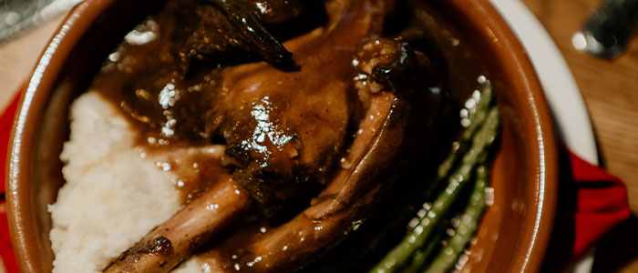 Braised lamb shank at Leku Ona Restaurant Boise Idaho, with mashed potatoes and green beans.