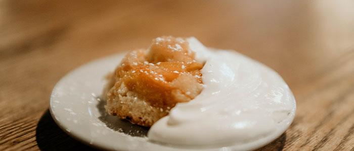 A dessert with caramelized fruit and whipped cream at Leku Ona Restaurant Boise Idaho.