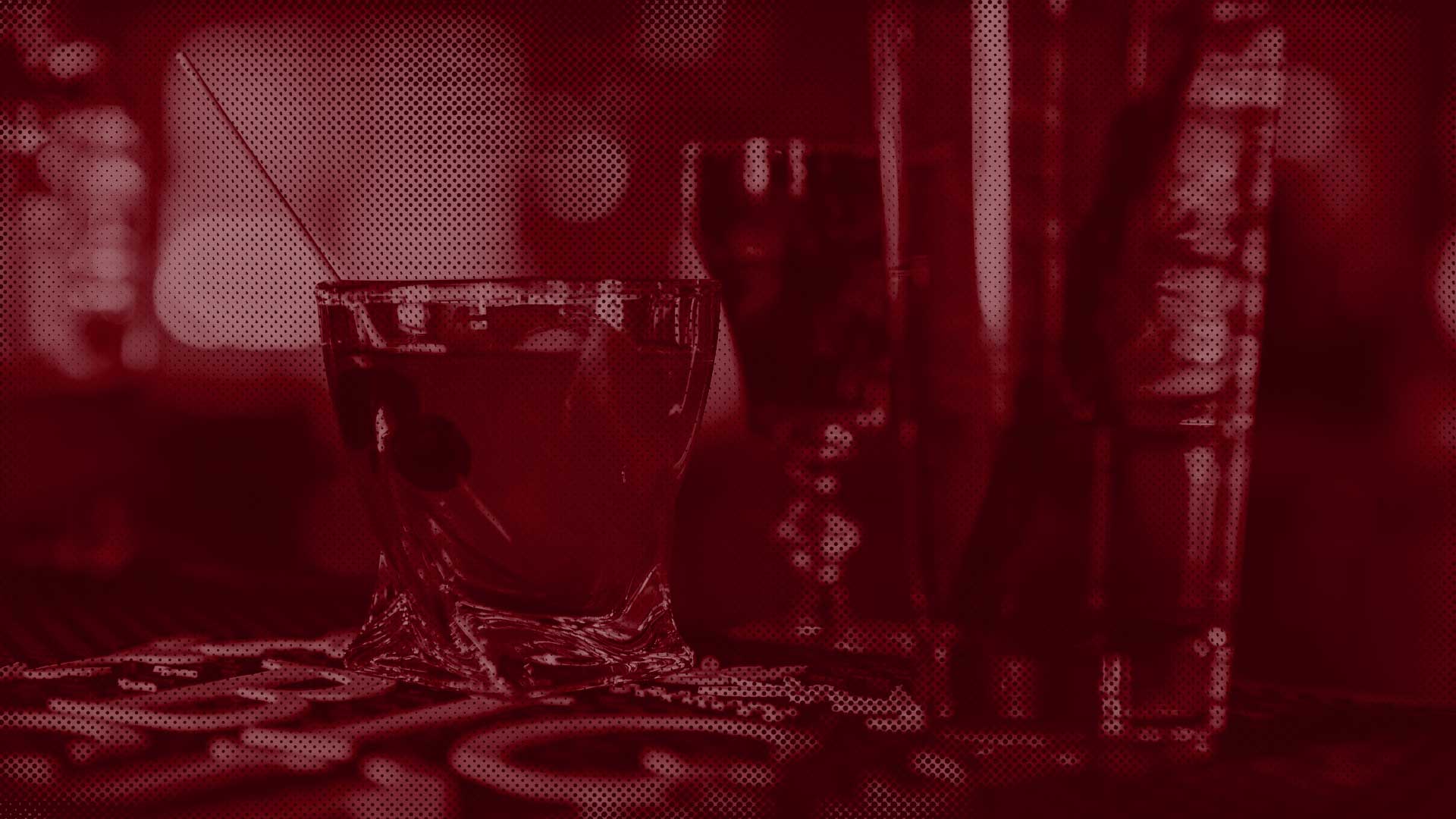 A cocktail glass with a stirrer and cherry at Leku Ona Restaurant Boise Idaho’s inviting bar.