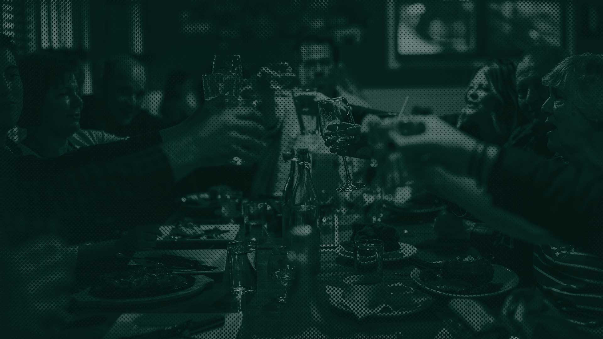 A group toasts around a dinner table at Leku Ona Restaurant in Boise, Idaho.