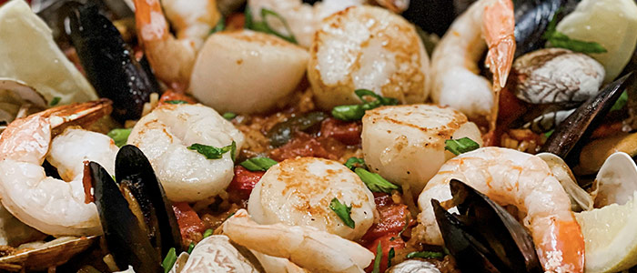Close-up of seafood paella at Leku Ona Restaurant Boise Idaho, with shrimp, scallops, and mussels.